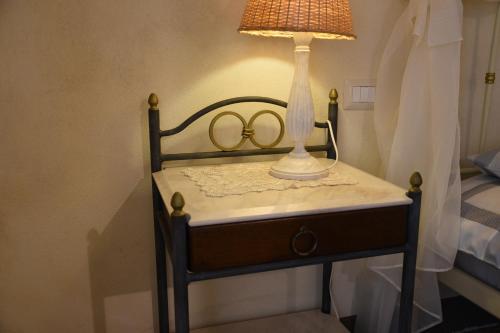 a table with a lamp and two rings on it at Agriturismo Poggio ai Legni in Sovicille