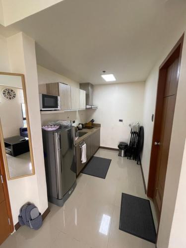 a small kitchen with a stainless steel refrigerator at Splendido Tower 2 Ann's Unit in Tagaytay
