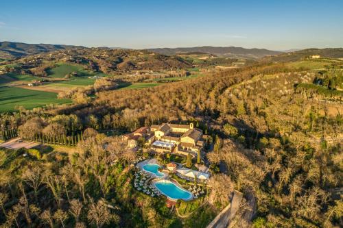an aerial view of a mansion with a swimming pool at Abbazia Collemedio Resort & Spa in Collazzone