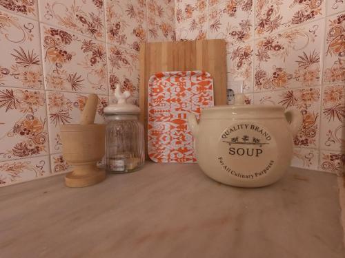 a shelf with a pot and a box on a table at Carlo's Beach Guest House in Praia de Odeceixe