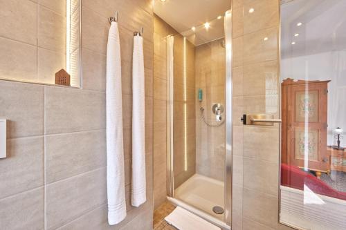 a shower with a glass door in a bathroom at Gästehaus Angela in Garmisch-Partenkirchen