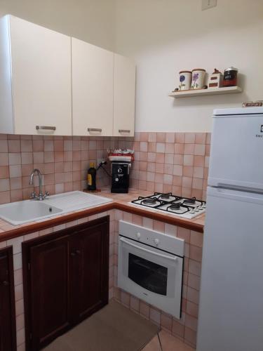 a kitchen with a sink and a stove top oven at Belvedere in Santa Margherita di Belice