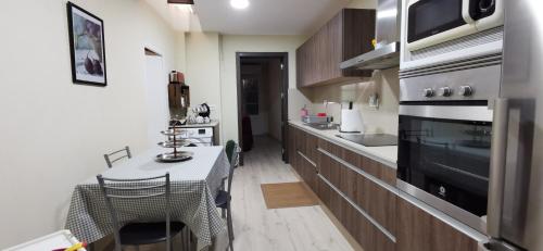 a small kitchen with a table and a stove at Cal Felico 