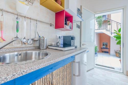 a kitchen with a sink and a counter top at Il riad del capitano in Siracusa