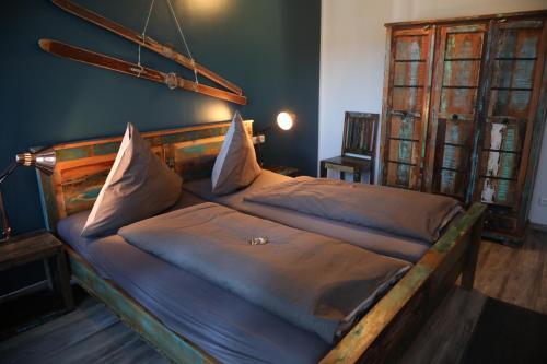a bedroom with a large bed with a wooden headboard at Studio im Loft in Oberstdorf