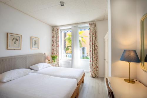 מיטה או מיטות בחדר ב-Piccolo Hotel