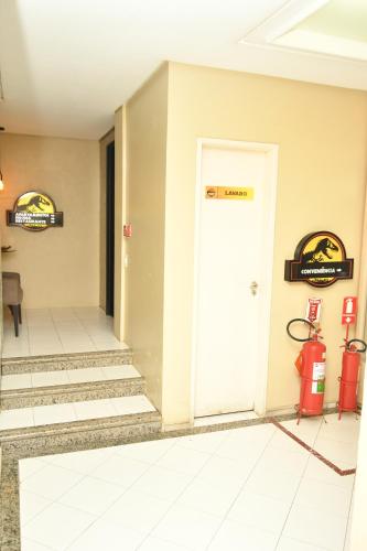 a room with a fire hydrant and a white door at Troodon Park Hotel in Sousa