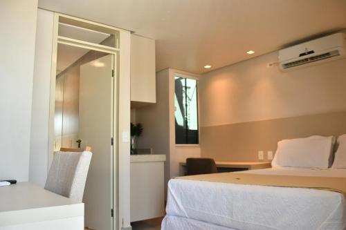 a bedroom with a bed and a desk with a chair at Troodon Park Hotel in Sousa