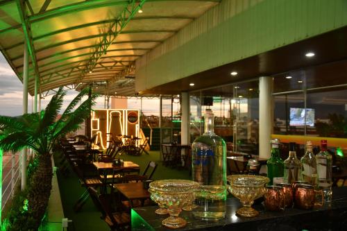 a restaurant with a bottle of wine on a table at Troodon Park Hotel in Sousa