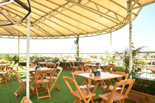 a group of tables and chairs under a tent at Troodon Park Hotel in Sousa