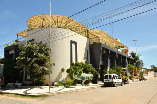 a building with a horse statue in front of it at Troodon Park Hotel in Sousa