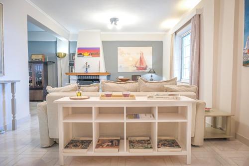 a living room with a couch and a table at Green House Ariadni in Artemida