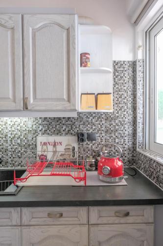 a kitchen with a red appliance on a counter at Green House Ariadni in Artemida
