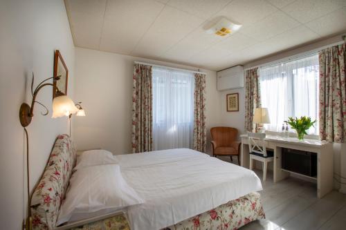 Ένα ή περισσότερα κρεβάτια σε δωμάτιο στο Piccolo Hotel