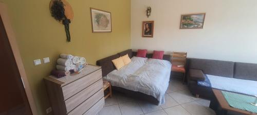 a small bedroom with a bed and a dresser at Apartments Ivanka G in Malinska