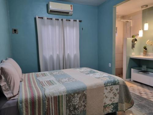 a bedroom with a bed and a window with a heater at Casa 170 in Belém
