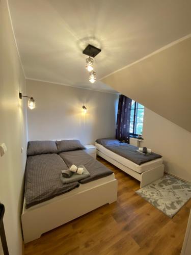 a bedroom with two beds and a staircase at Zatoka Stegna in Stegna