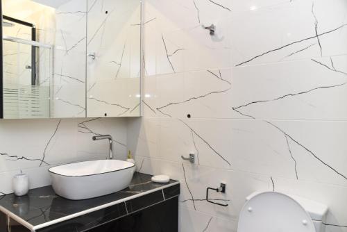 a white bathroom with a sink and a toilet at Casa Galini in Kalamata