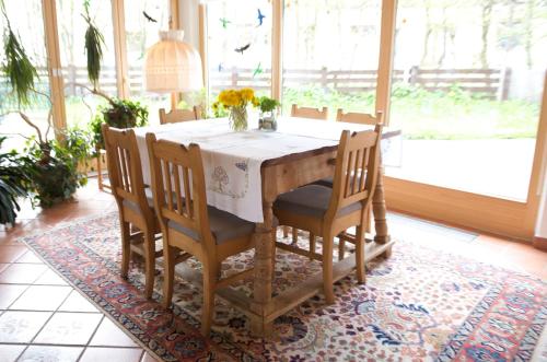a dining room table with chairs and a white table cloth at Bio-Landpension Monika in Leutasch
