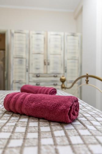 two towels sitting on a table in a bathroom at Ligaridia Apartments in Moutsoúna