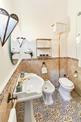 a bathroom with a sink and a toilet at Louis Mary Apartment in Gallipoli