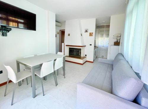 a living room with a table and a couch at Villa Ivona in Bibione