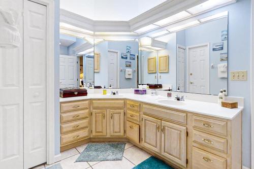 a bathroom with a sink and a large mirror at 4954 Summer Beach Blvd in Fernandina Beach