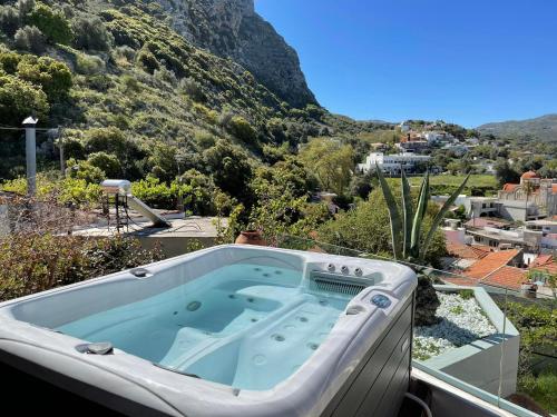 a jacuzzi tub on the roof of a house at Domus Polymnia, hospitality at its best! in Spílion