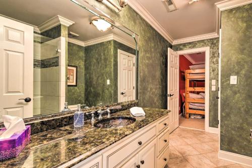 Un baño con lavabo y un espejo grande. en Dock and Fire Pit Mt Gilead Villa on Lake Tillery, en Mount Gilead