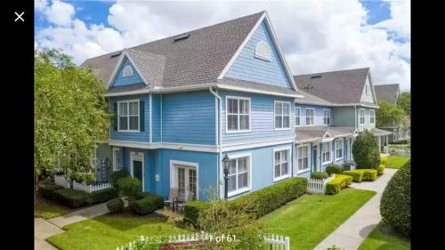 a blue house with a gray roof at Orlando House in Kissimmee