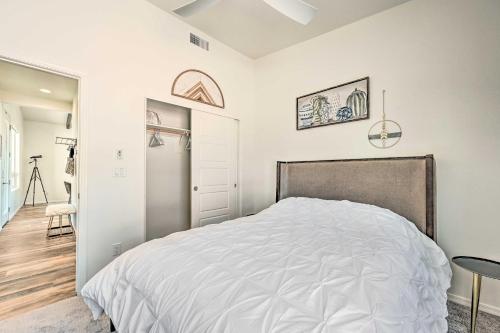a white bedroom with a bed and a table at Mtn Views and Gas Fire Pit Luxe Pine Escape! in Pine