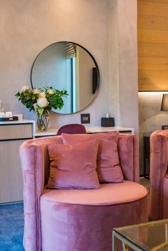 a living room with a couch and a mirror at Vivari Hotel and Spa by Mantis in Johannesburg