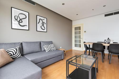 a living room with a couch and a table at chicStays Apartment Ciutadella Park in Barcelona
