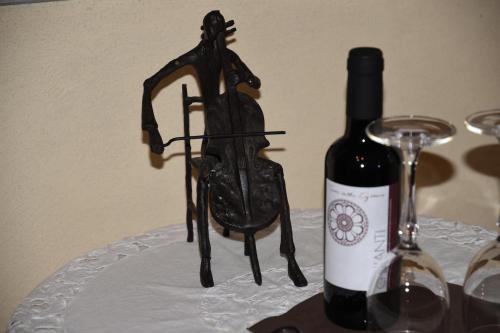 a bottle of wine sitting next to a wine glass at Agriturismo Poggio ai Legni in Sovicille