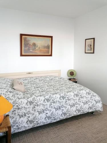 a bedroom with a bed and a picture on the wall at DUNKE in Dunkerque