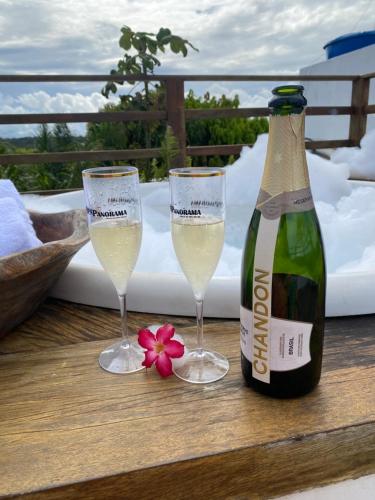 two glasses of champagne and a bottle of wine at Pipa Panorama Aparthotel in Pipa