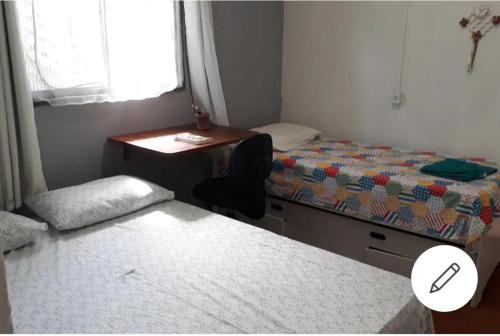 a bedroom with a desk and a bed and a desk and a chair at Casa amora olinda in Olinda