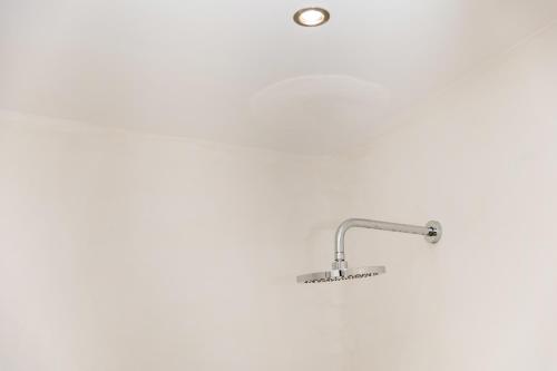 a shower with a shower head in a bathroom at Krina Mare Boutique Hotel in Naxos Chora