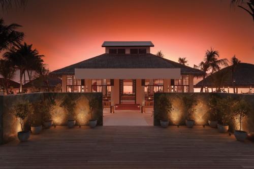 a gazebo with a sunset in the background at OBLU SELECT Lobigili - Premium All-Inclusive with Free Transfers in Male City