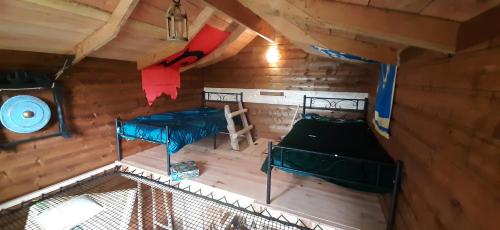 an overhead view of a cabin with two beds at Cabane du Druide Domaine de Fangorn in Glux