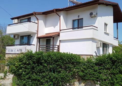 a white building with trees in front of it at Villa Kalina in Lozenets