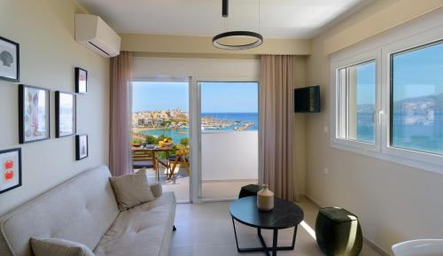 a living room with a couch and a table at Angelique Luxury apartment in Agios Nikolaos