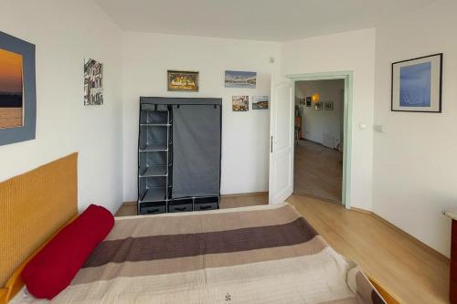 a room with a bed with a red pillow on it at Highway House in Kecskemét