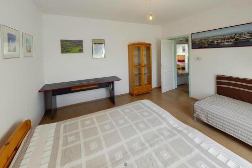 a bedroom with a bed and a desk on the wall at Highway House in Kecskemét
