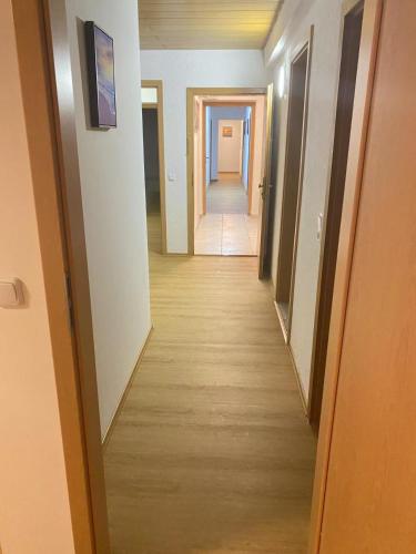 a hallway with a long corridor with doors and a hallway at Panda Royal Klettgau in Klettgau