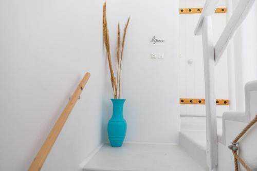 a blue vase sitting on the floor in a room at Krina Mare Boutique Hotel in Naxos Chora