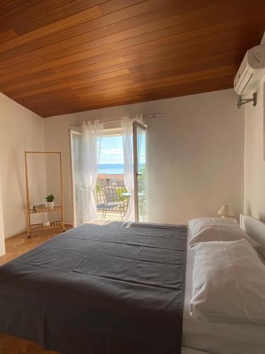 a bedroom with a bed with a view of the ocean at Studio apartman More in Baška Voda