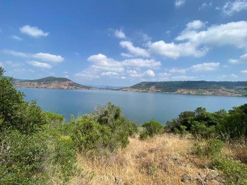 a view of a lake with mountains in the background at DOMAINE MAXXIM in Clermont-lʼHérault