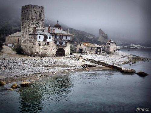 an old castle on the shore of a body of water at Panorama Spa Hotel in Ouranoupoli