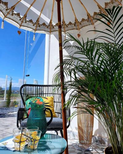 a table with a vase on a table with an umbrella at L'Hotelet del Delta - adults in Deltebre